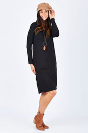 Model Gemma wearing size S of the Reversible Dress in colour Black (Black), from the front, showing the whole outfit