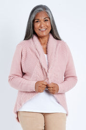 Model Nadine wearing size S of the Faux Fur Cardigan in colour Rose (Pink), from the front, cropped image