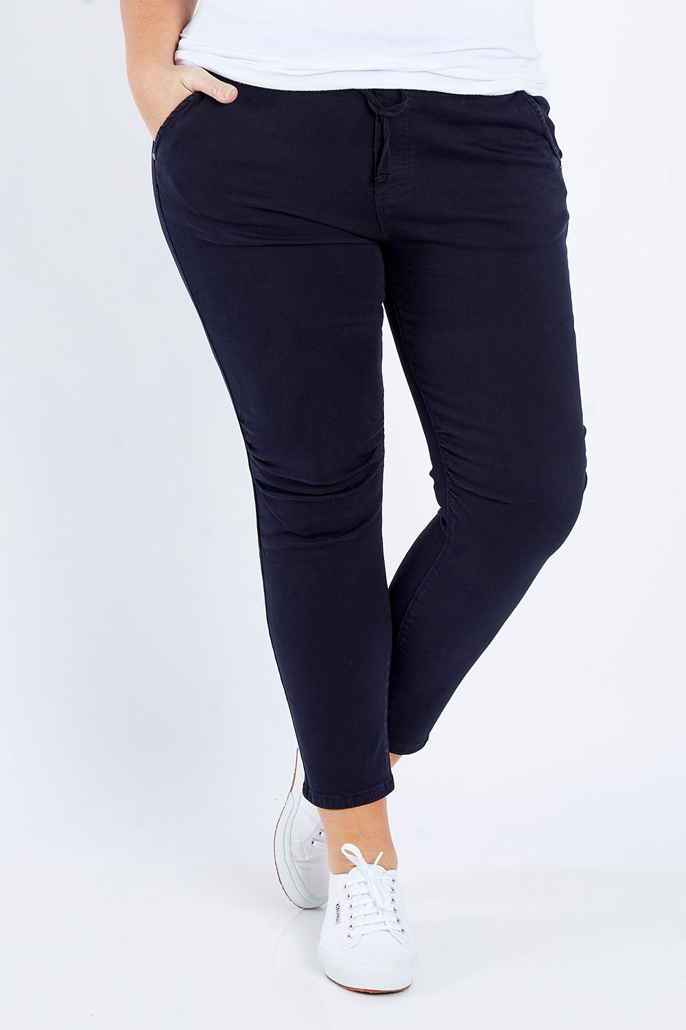 Model Fiona wearing size XL of the Jogger Jean in colour Navy (Blue), from the front, cropped image