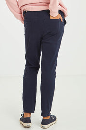 Model Olivia wearing size S of the Jogger Jean in colour Navy (Blue), from the back