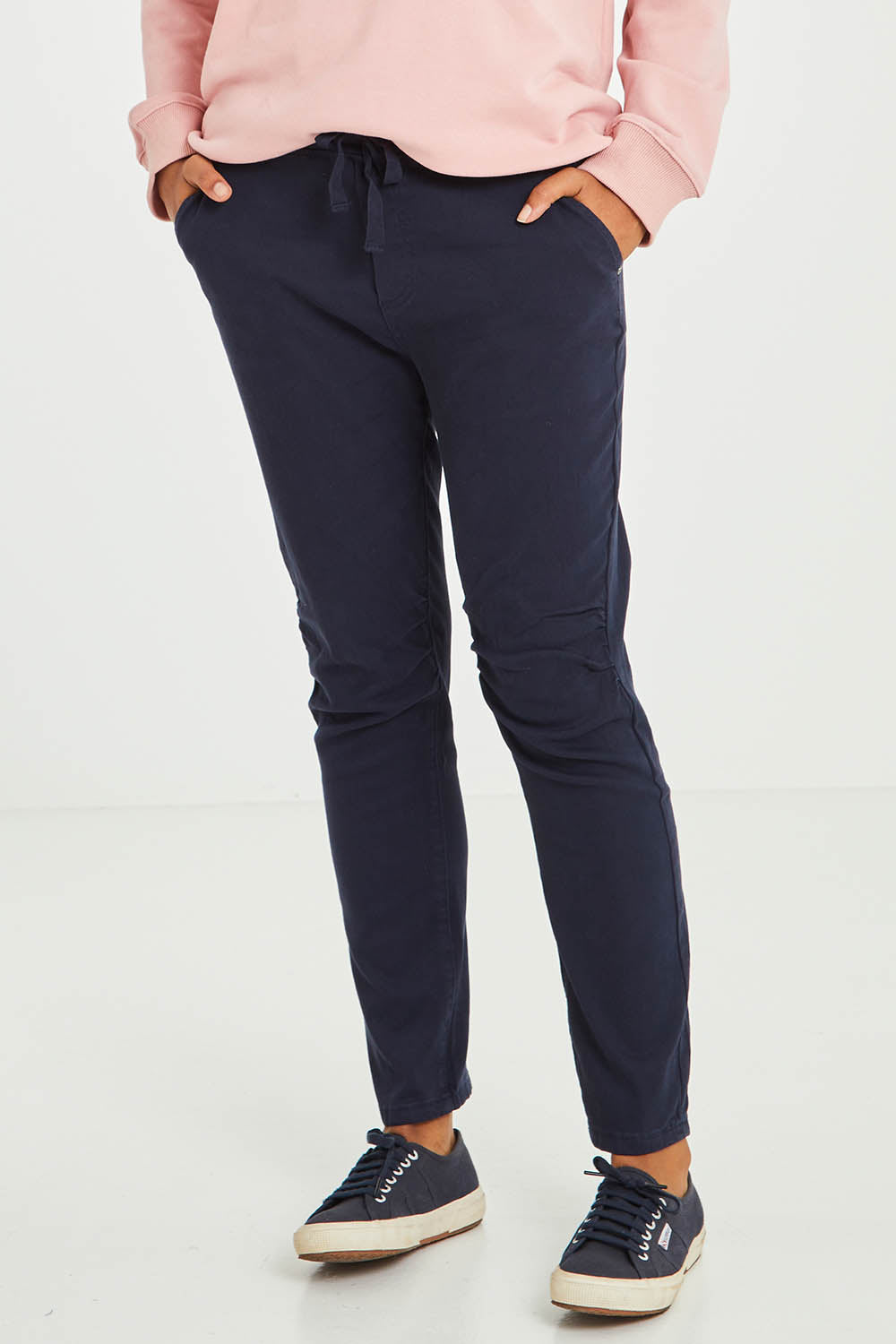 Model Olivia wearing size S of the Jogger Jean in colour Navy (Blue), from the front, cropped image