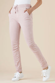 A model wearing the Jogger Jean in colour Pink (Pink), from the front, cropped image