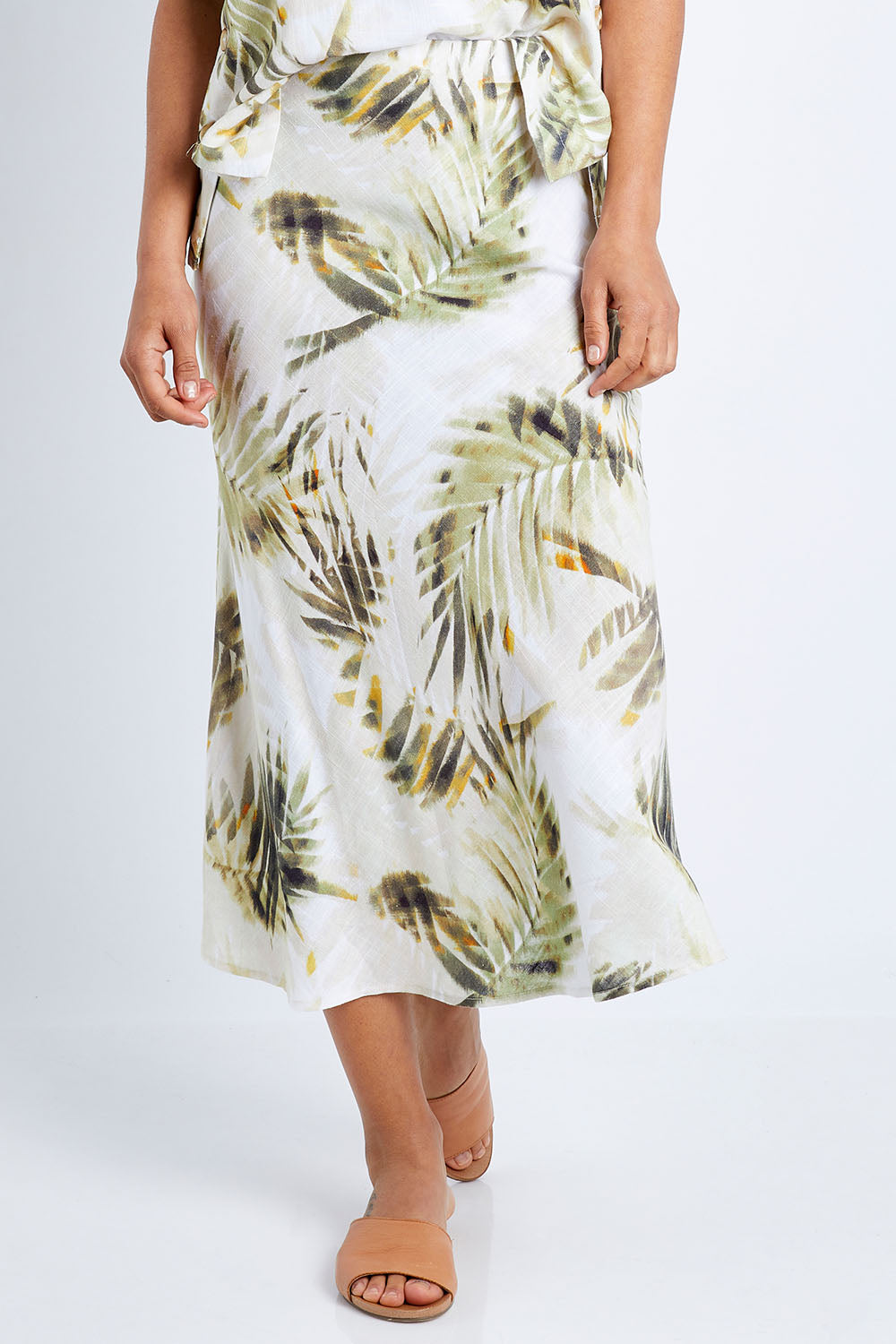 Model Pamela wearing size S of the Palm Print Skirt in colour Print (Green), from the front, cropped image