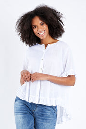 Model Schanez wearing size S of the Frill Detail Button Top in colour White (White), from the front, cropped image