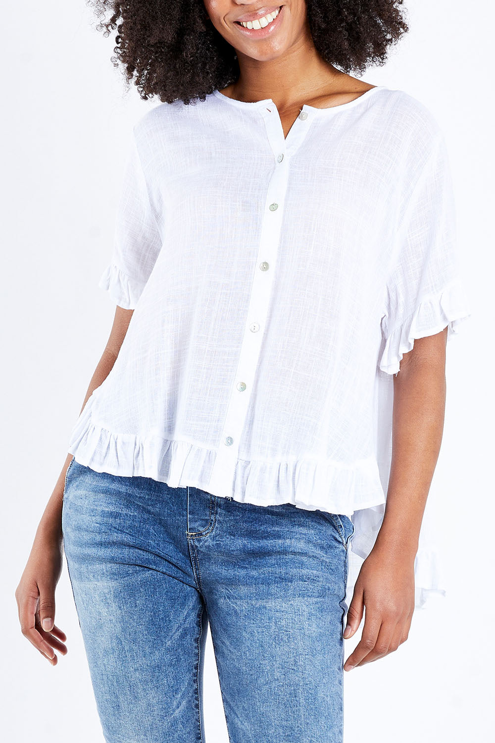 Model Schanez wearing size S of the Frill Detail Button Top in colour White (White), from the front, cropped image