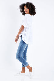Model Schanez wearing size S of the Frill Detail Button Top in colour White (White), from the front, showing the whole outfit