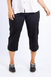 Model Laura wearing size L of the Santorini Cotton Pant in colour Black (Black), from the front, cropped image