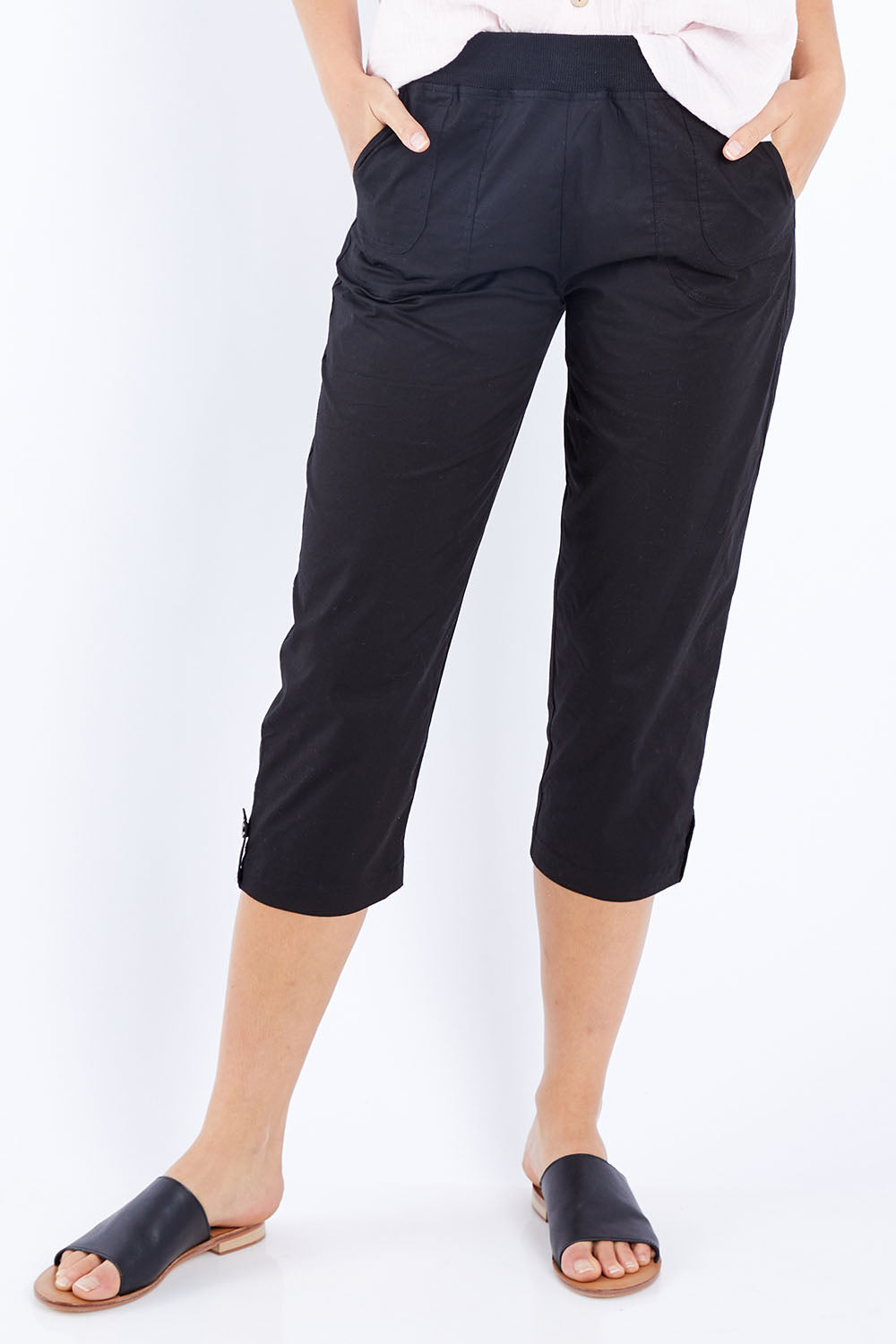 Model Madeline wearing size S of the Santorini Cotton Pant in colour Black (Black), from the front, cropped image