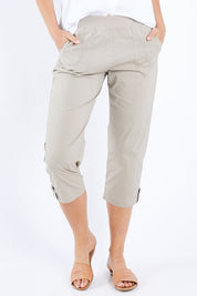 Model Madeline wearing size S of the Santorini Cotton Pant in colour Natural, from the front, cropped image