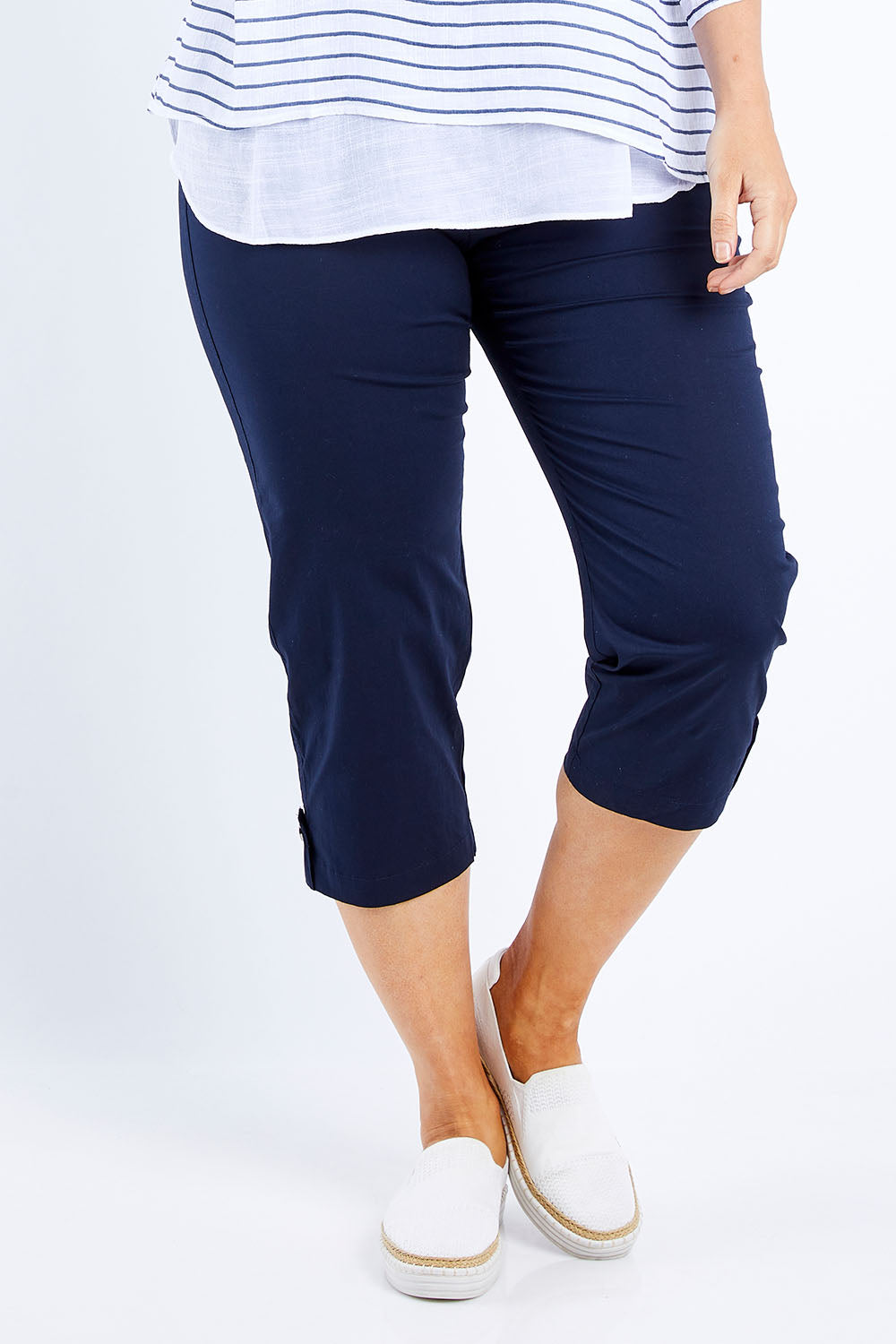 Model Laura wearing size L of the Santorini Cotton Pant in colour Navy (Blue), from the front, cropped image