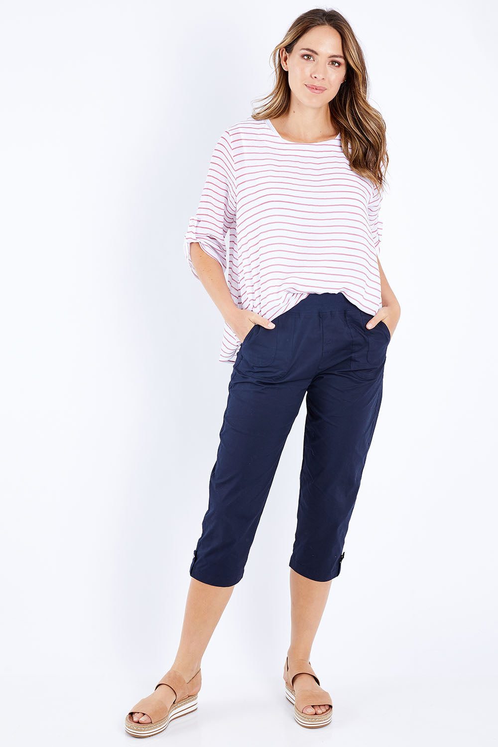 Model Madeline wearing size S of the Santorini Cotton Pant in colour Navy (Blue), from the front, showing the whole outfit