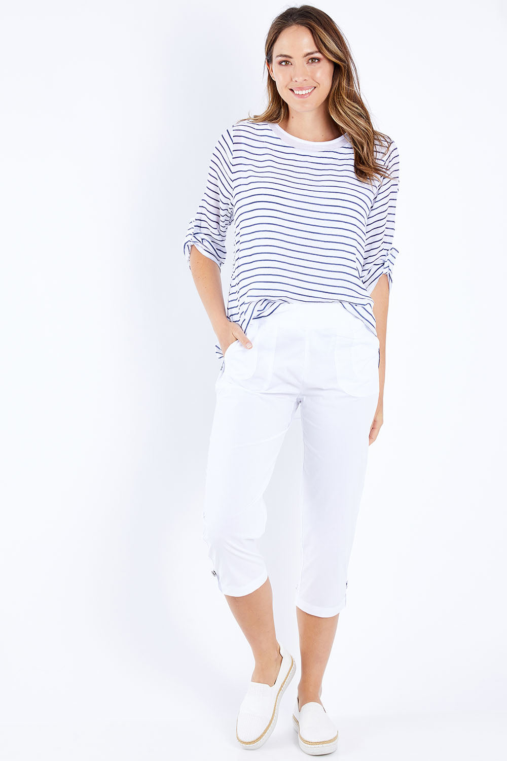 Model Madeline wearing size S of the Santorini Cotton Pant in colour White (White), from the front, showing the whole outfit