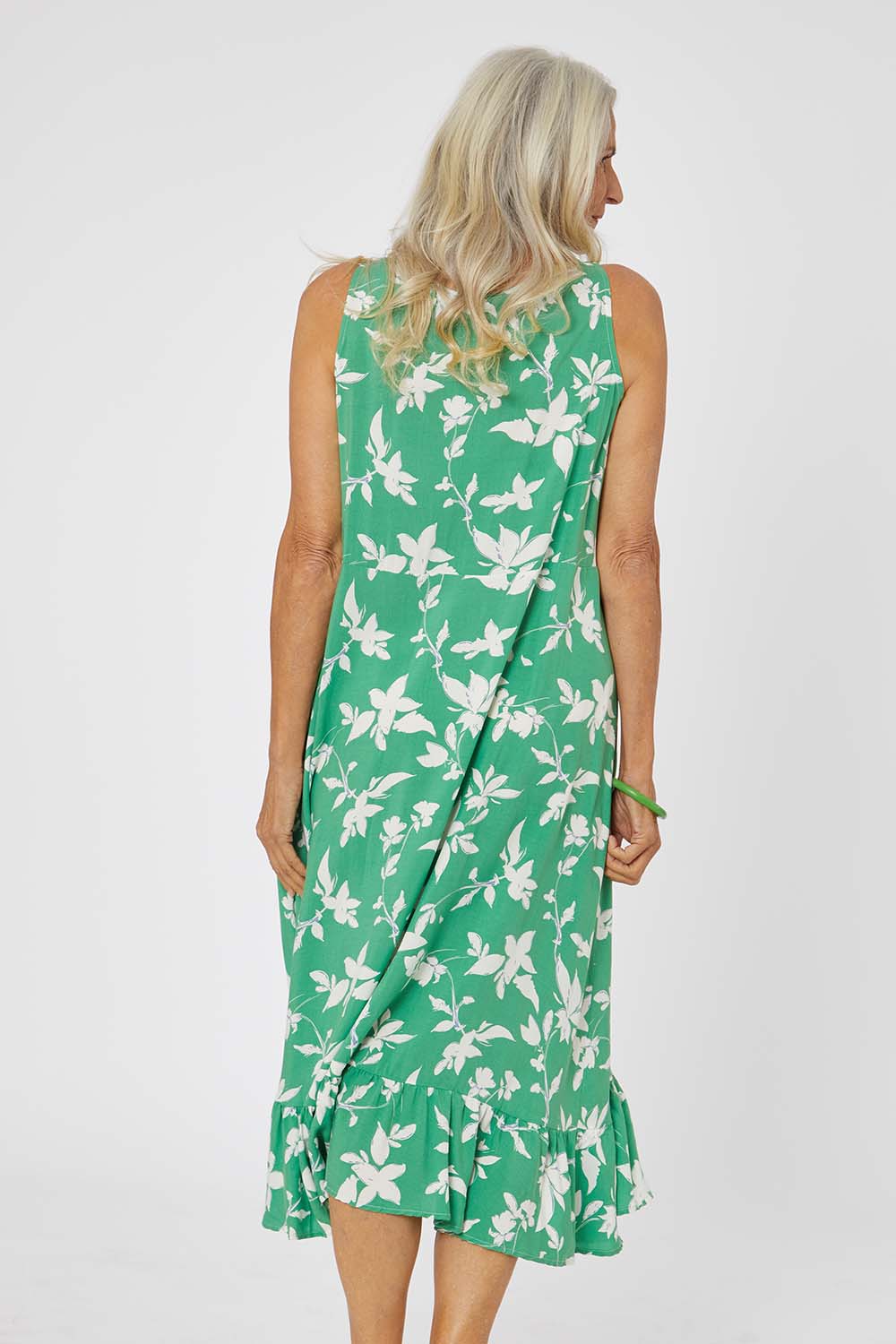 Model Rachel wearing size S of the Floral Print Sun Dress in colour Green (Green), from the back