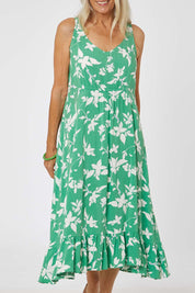 Model Rachel wearing size S of the Floral Print Sun Dress in colour Green (Green), from the front, cropped image