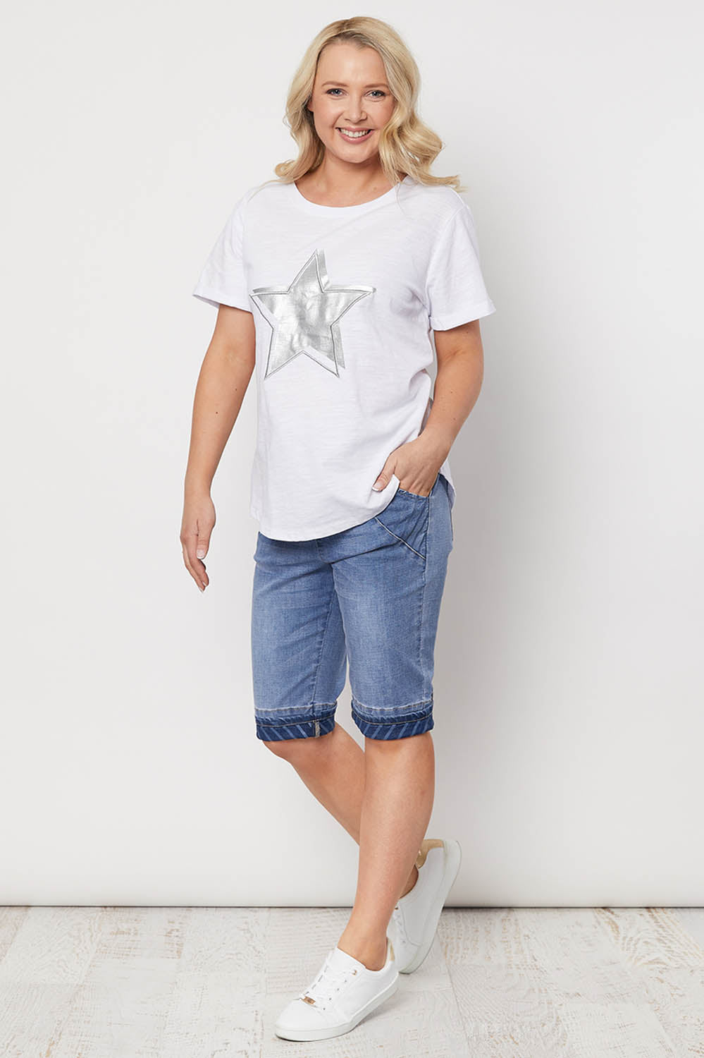A model wearing the Jogger Short in colour Denim (Blue), from the front, showing the whole outfit
