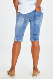 Model Olivia wearing size S of the Jogger Short in colour Denim (Blue), from the back