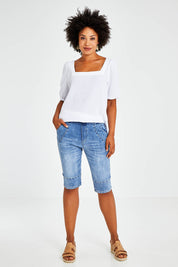 Model Olivia wearing size S of the Jogger Short in colour Denim (Blue), from the front, showing the whole outfit