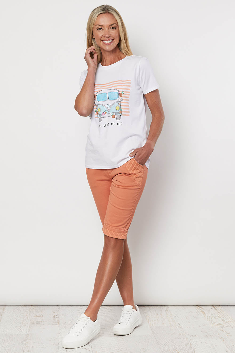 A model wearing the Jogger Short in colour Orange, from the front, showing the whole outfit