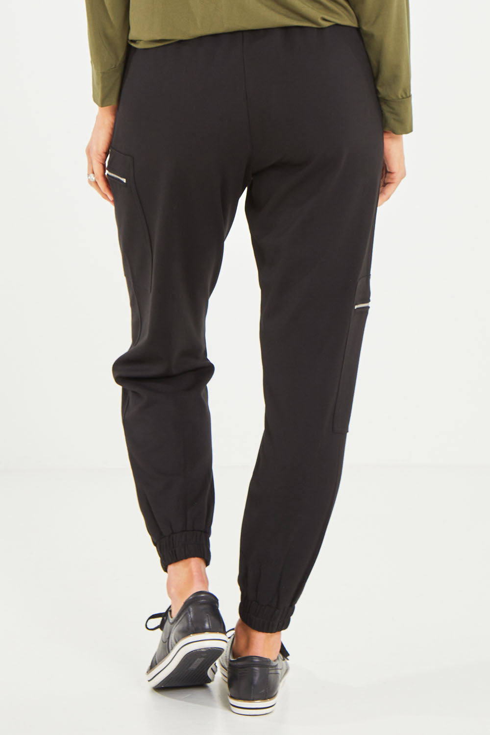 Model Kelly wearing size S of the Zip Pocket Pant in colour Black (Black), from the back