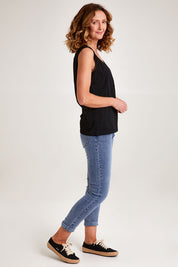Model Emma wearing size S of the Sophie Mom Jean in colour Denim (Blue), from the front, showing the whole outfit