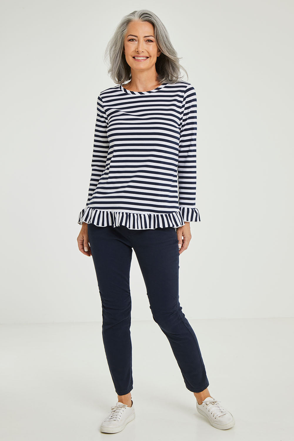 Model Luisa wearing size S of the Frilled Hem Stripe Tee in colour Navy (Blue), from the front, showing the whole outfit