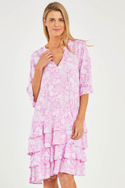 Model Kelly wearing size S of the Print Layered Dress in colour Lolly (Pink), from the front, cropped image