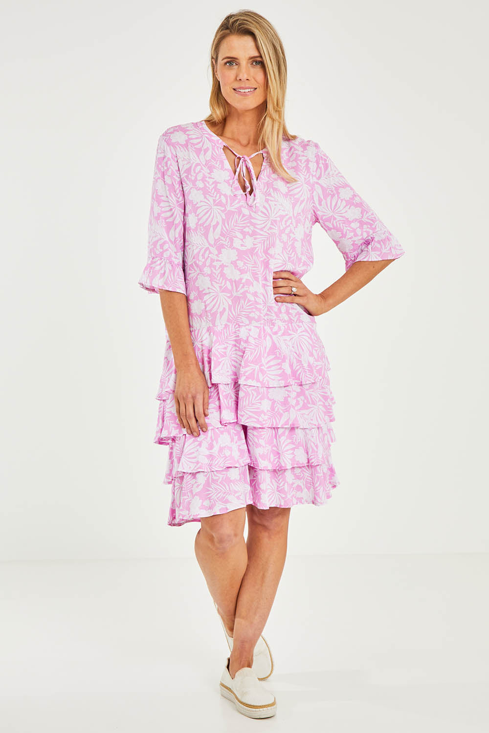 Model Kelly wearing size S of the Print Layered Dress in colour Lolly (Pink), from the front, showing the whole outfit