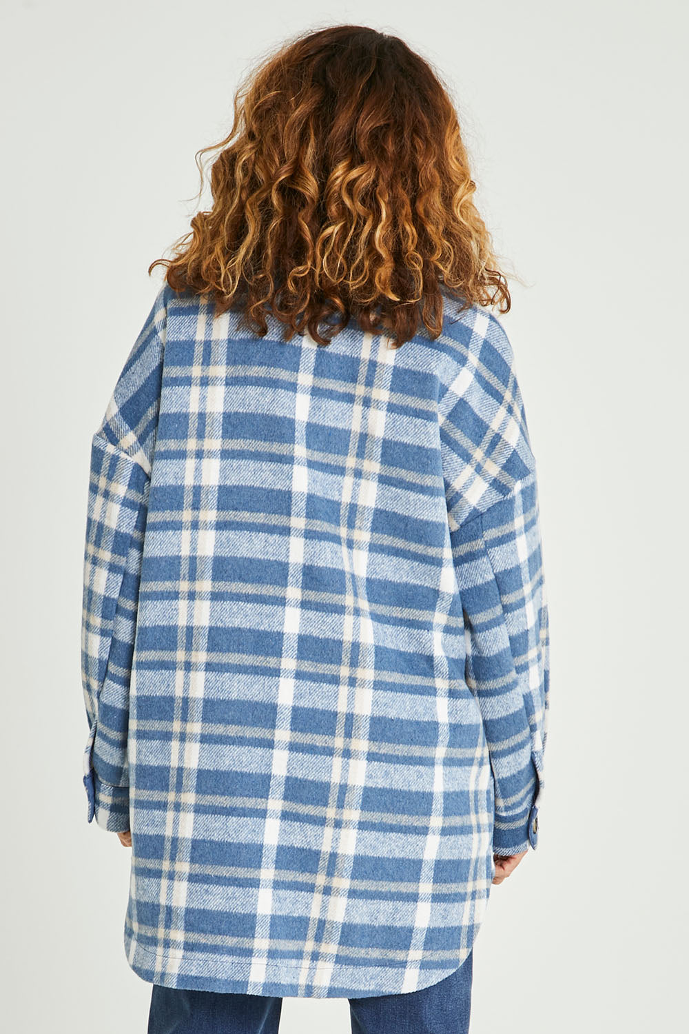 Model Emma wearing size S of the Perisher Check Shacket in colour Cornflower (Blue), from the back