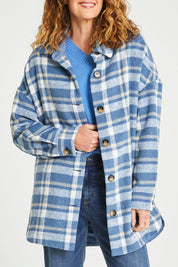 Model Emma wearing size S of the Perisher Check Shacket in colour Cornflower (Blue), from the front, cropped image