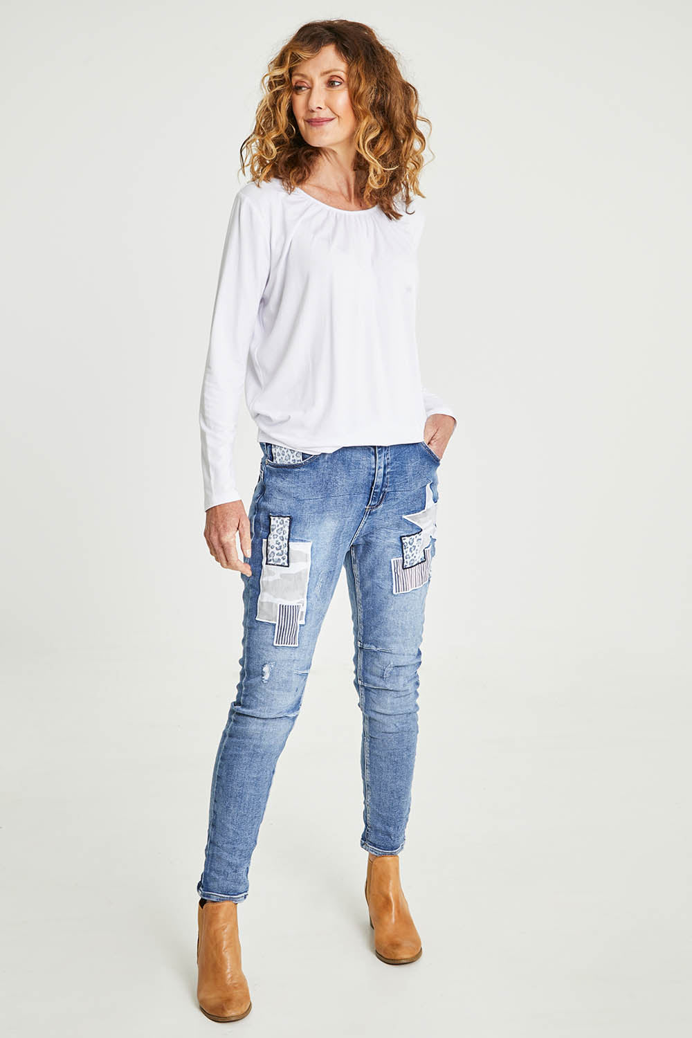 Model Emma wearing size S of the Stella Patch Denim Jean in colour Denim (Blue), from the front, showing the whole outfit