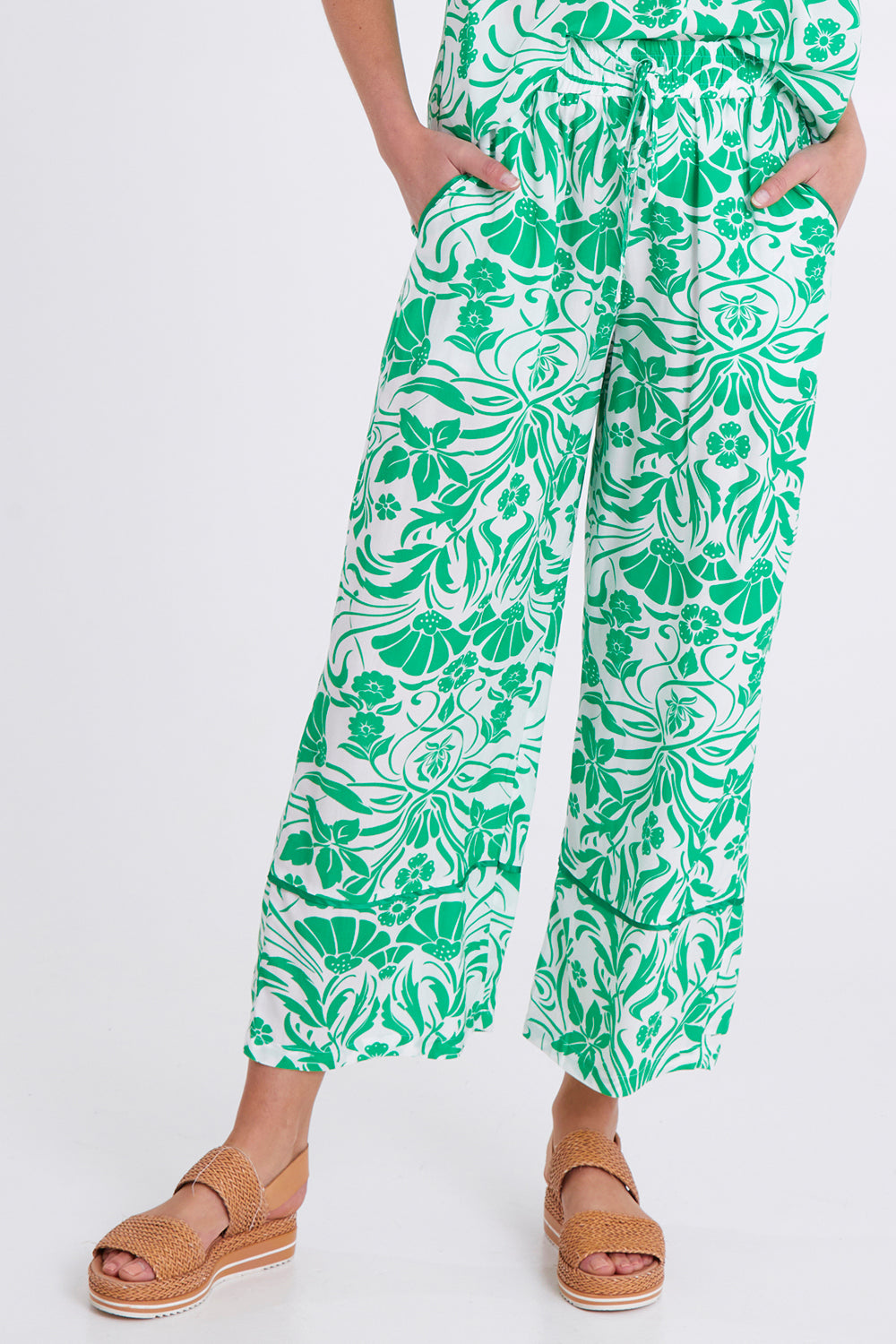Model Madeline wearing size S of the Paradise Pant in colour Green (Green), from the front, cropped image