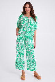Model Madeline wearing size S of the Paradise Pant in colour Green (Green), from the front, showing the whole outfit
