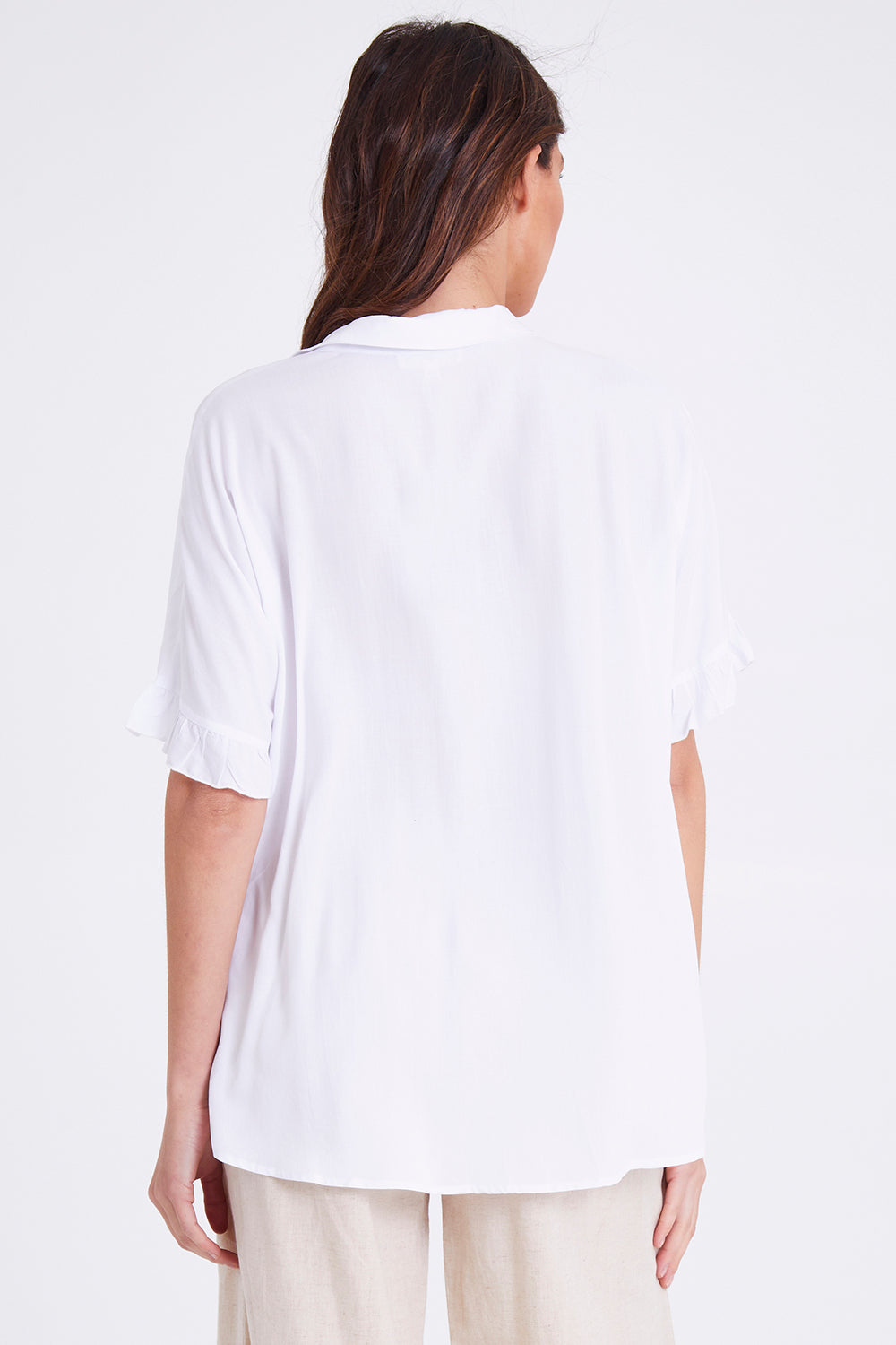 Model Madeline wearing size S of the Kylie Shirt in colour White (White), from the back