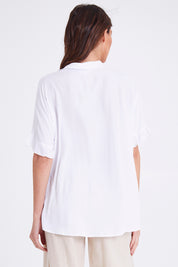 Model Madeline wearing size S of the Kylie Shirt in colour White (White), from the back