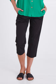 Model Madeline wearing size S of the Santorini Cotton Pant in colour Black (Black), from the front, cropped image
