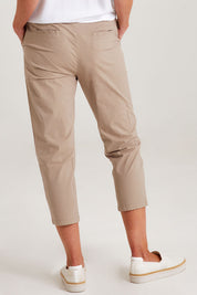 Model Emma wearing size S of the Santorini Cotton Pant in colour Natural, from the back