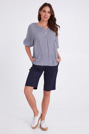 Model Madeline wearing size S of the Santorini Cotton Short in colour Navy (Blue), from the front, showing the whole outfit