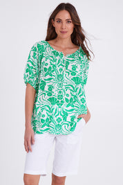 Model Madeline wearing size S of the Santorini Cotton Short in colour White (White), from the front, cropped image