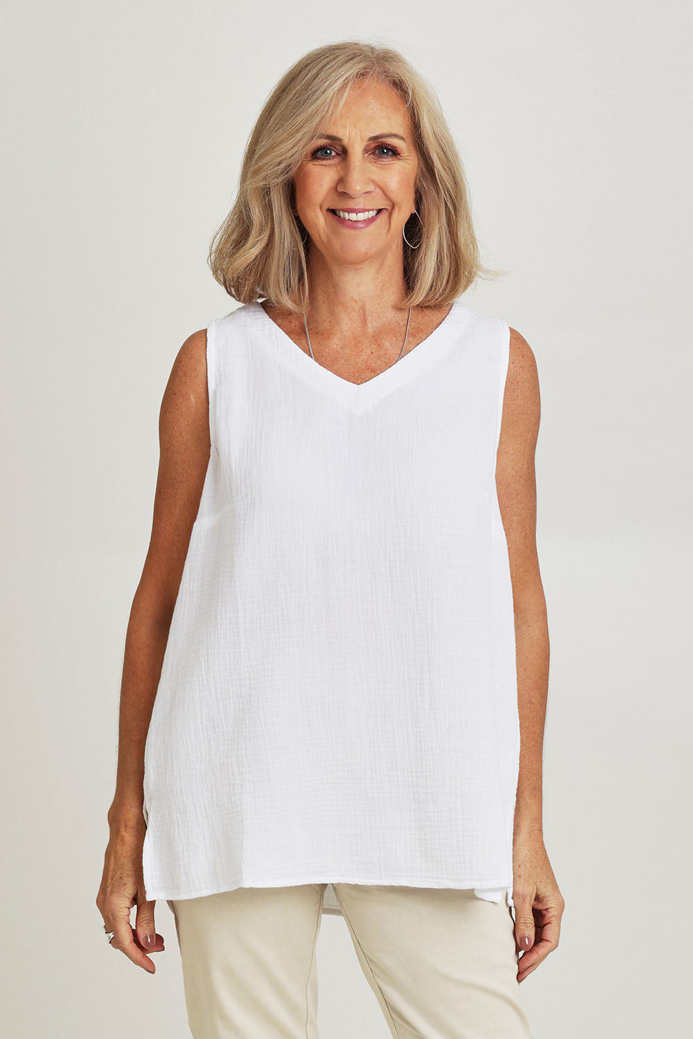 Model Sandy wearing size S of the Byron Cotton Tank in colour White (White), from the front, cropped image