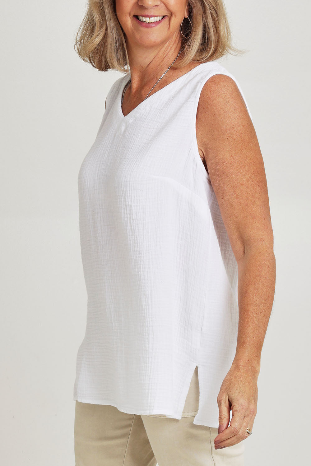 Model Sandy wearing size S of the Byron Cotton Tank in colour White (White), from the front, cropped image