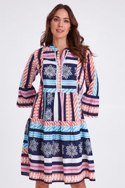 Model Madeline wearing size S of The Bondi Cotton Dress in colour Navymulti (Blue), from the front, cropped image