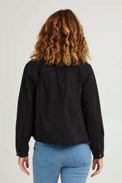 Model Emma wearing size S of the Collarless Denim Jacket in colour Black (Black), from the back