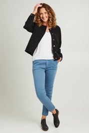 Model Emma wearing size S of the Collarless Denim Jacket in colour Black (Black), from the front, showing the whole outfit