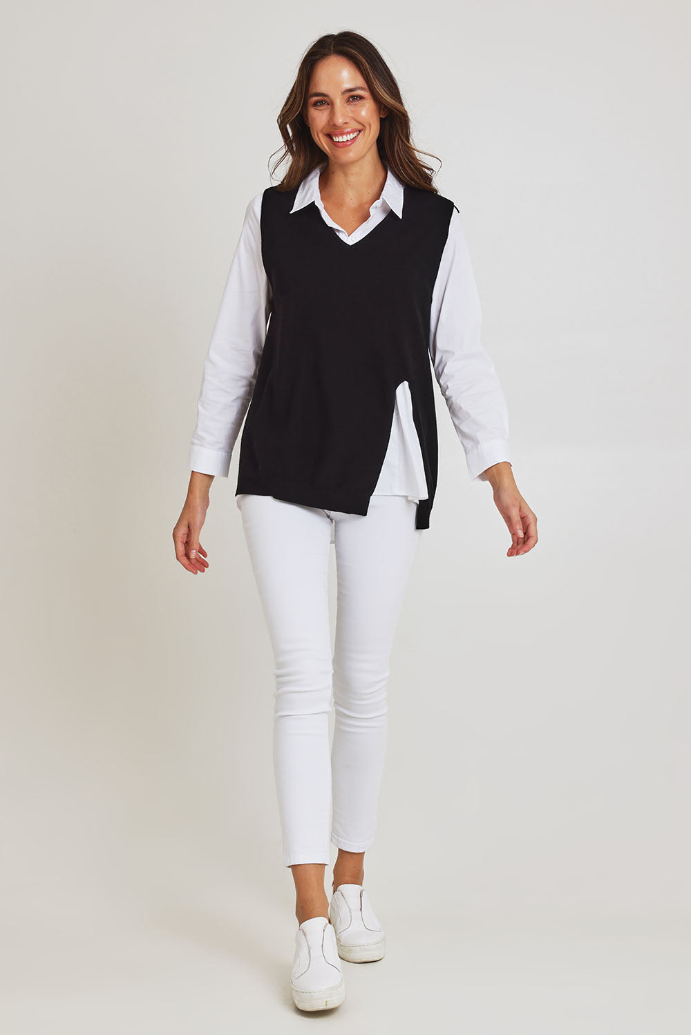 Model Madeline wearing size S of the Vicky Side Split Knit Vest in colour Black (Black), from the front, showing the whole outfit