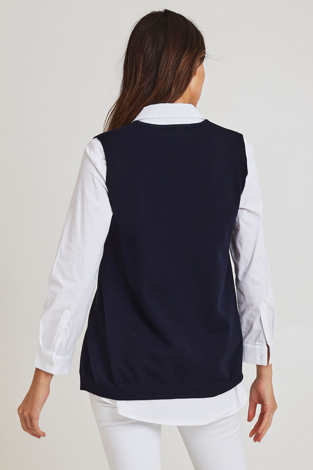 Model Madeline wearing size S of the Vicky Side Split Knit Vest in colour Navy (Blue), from the back