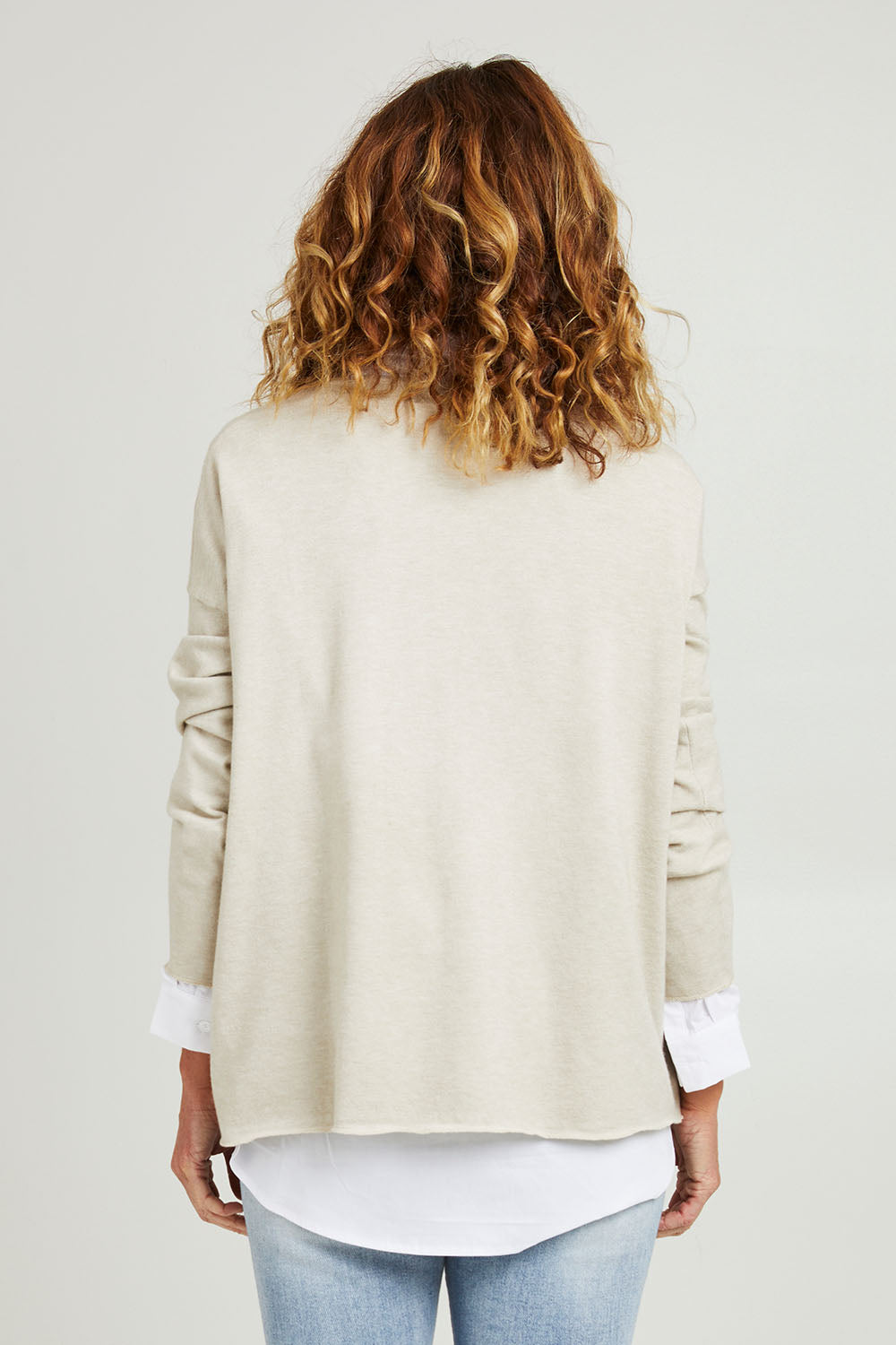 Model Emma wearing size S of the Amour Knit in colour Natural, from the back
