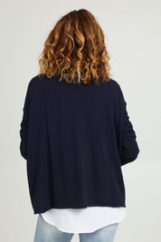 Model Emma wearing size S of the Amour Knit in colour Navy (Blue), from the back