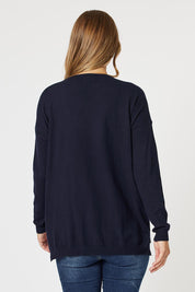 A model wearing the Cest La Vie Knit in colour Navy (Blue), from the back