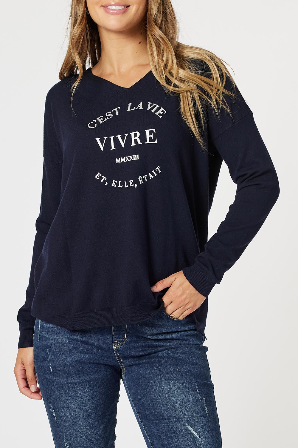 A model wearing the Cest La Vie Knit in colour Navy (Blue), from the front, cropped image