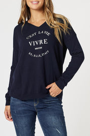 A model wearing the Cest La Vie Knit in colour Navy (Blue), from the front, cropped image